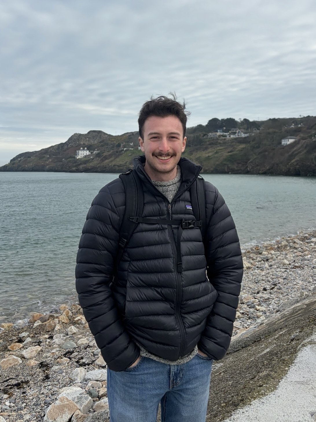 Elliot Gross standing on a rocky coastline